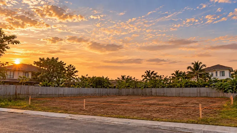 Illustrative render: a cleared lot staked out for construction